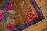 Distressed red seeded corner spandrel and sapphire blue blossom border on vintage Oushak.