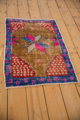 Distressed Oushak rug, sapphire blue vine border, magenta blossoms, and red spandrel.