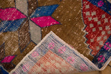 Distressed Oushak rug's magenta, blue pile with exposed foundation and intact side selvage.
