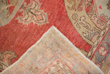 Folded corner of a distressed Oushak runner showing its hand-knotted back and secure selvage.