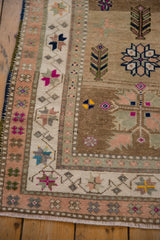 Vintage Distressed Oushak rug corner, showing abrashed field, starburst border, and even wear.