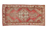Vintage distressed Oushak runner with a stepped center medallion in faded cherry red and ivory.