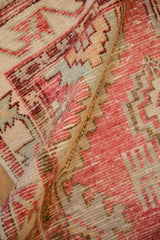 Detailed texture of a vintage distressed Oushak rug showing low, even wear across the hand-knotted pile.