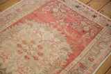 Even wear to the knot heads on a distressed Oushak rug in blush pink and silver.