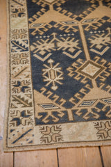 Distressed vintage Oushak corner with dark denim royal blue, beige geometric hook and latch patterns.