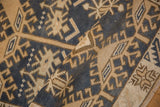 Folded distressed Oushak rug texture, geometric denim blue and beige patterns.