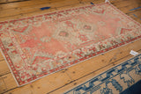 Distressed blush and pale seafoam green Oushak rug runner with a serrated palmette spandrel.