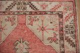 Mostly even wear on the geometric border and corner spandrel of this vintage Oushak rug.