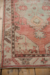 Geometric corner border of a vintage Oushak rug with a time-softened, even wear.