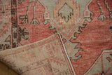 Hand-knotted foundation visible on the back of a distressed Turkish Oushak rug.