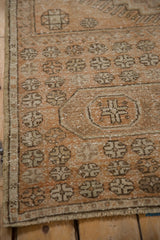 Artfully distressed texture of the vintage Oushak runner, featuring geometric motifs and soft neutral tones.