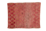 Distressed Tulu square rug with a checkered pattern and shaggy high pile in shades of rose and raspberry red.