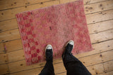 Overhead view showing the scale and shaggy, distressed pile of a pink Tulu rug.