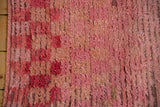 Textural close-up of a distressed Tulu rug's shaggy pile and exposed knot heads.