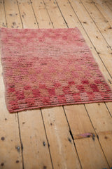 Angled view of the vintage distressed Tulu rug showing its shaggy pile and texture.