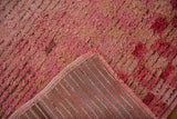 Corner view showing the hand-knotted foundation and shaggy pink pile of a Tulu rug.
