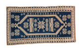 Vintage distressed Oushak rug in cobalt blue and sand with a serrated geometric medallion and starburst details.