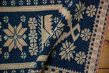 Textural detail of a distressed Oushak rug with a soft fold revealing its cobalt blue and sand pile.