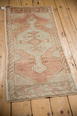 Distressed vintage Oushak runner lower floral niche, abrashed field in sandalwood, ivory, oxidized silver with even wear.