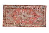 Distressed Oushak rug runner with a diamond medallion in dusty rose, silver, and pops of turquoise.