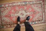 The time-softened texture and scale of a vintage Oushak runner viewed underfoot.
