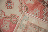 Detail of the hand-knotted foundation on the reverse of a distressed vintage Oushak rug.