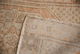 Vintage distressed Oushak rug's foundation and worn pile texture, antique ivory, pale rust hues.