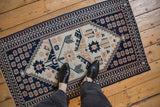 Distressed vintage Dosemealti rug runner with geometric patterns, viewed from above for scale.