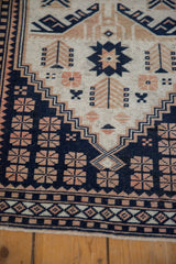 Detail of corner spandrels showing geometric blossoms in navy blue, dusty rose, and sand.
