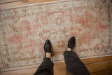 Overhead view showing the scale and worn texture of a vintage distressed Oushak runner.