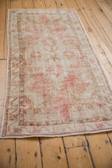 Vintage distressed Oushak rug runner viewed from a side angle, showcasing its time-softened colors.