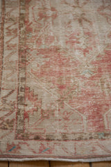 Close view of the mostly even wear and low pile texture of a distressed Turkish Oushak rug.