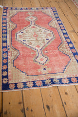 Angled perspective of a distressed Oushak rug showing its stepped hexagonal medallion and abrashed field.
