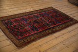 Angled view showcasing the intricate floral and ram's horn design of a Kurdish Hamadan rug.