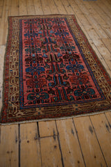 An angled view of the vintage Kurdish Hamadan rug, highlighting its full geometric design.