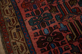 Close view of the low pile and stylized guls in dusty teal and sapphire blue on a vintage Kurdish rug.