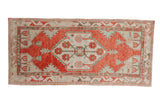 Vintage Oushak runner with a distressed red medallion, seafoam green accents, and ivory field.