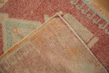 Distressed Kars rug pile in faded reds, ivory, showing abrashes and hand-knotted reverse.