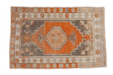 Vintage distressed Oushak rug with a hexagonal terracotta medallion, stepped silver corners, and floral border.