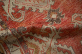 A soft fold reveals the worn knot heads and supple texture of this distressed Oushak rug.