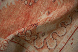 Textural detail of a distressed Oushak rug with a low pile in abrashed brick red and platinum.