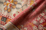 Textured pile of this distressed Oushak rug runner, with raspberry and gold.