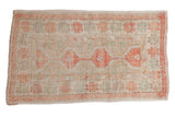 Vintage distressed Oushak rug with geometric medallions in a soft palette of pale terracotta and seafoam green.