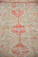 Low pile texture and exposed knot heads of a distressed vintage Oushak rug.