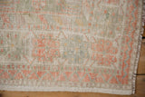 Corner detail of a distressed Oushak rug showing the worn, knot-head texture and secured fringe.