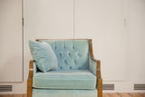 Tufted baby blue mohair velvet back, wooden arm of the chair, and matching pillow.