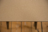 Surface detail of the vintage end table showing the light-colored, horizontal wood grain.