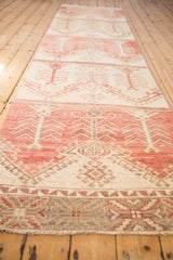 Distressed Oushak runner detail: faded raspberry, cream tree motifs, dusty silver border, and fringe.