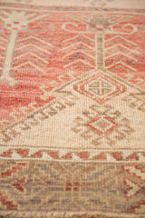 Distressed Oushak runner showing faded cream, blush, and silver partial tree-of-life motif.