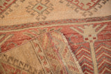 Distressed vintage Oushak runner, with faded raspberry, cream pile, geometric design, reverse foundation.
